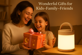 Woman and child opening a gift box with a lit lantern on a table.
